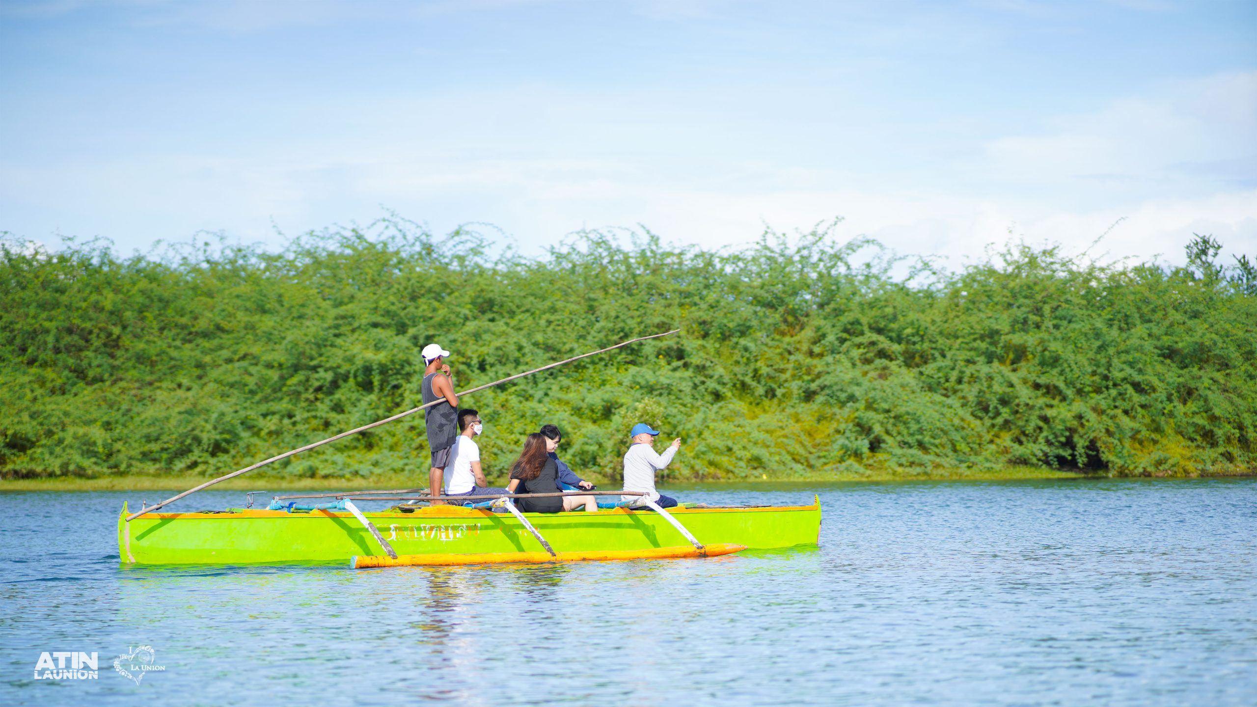 A group of people riding a boat at the Bakawan Eco Tourism Park.