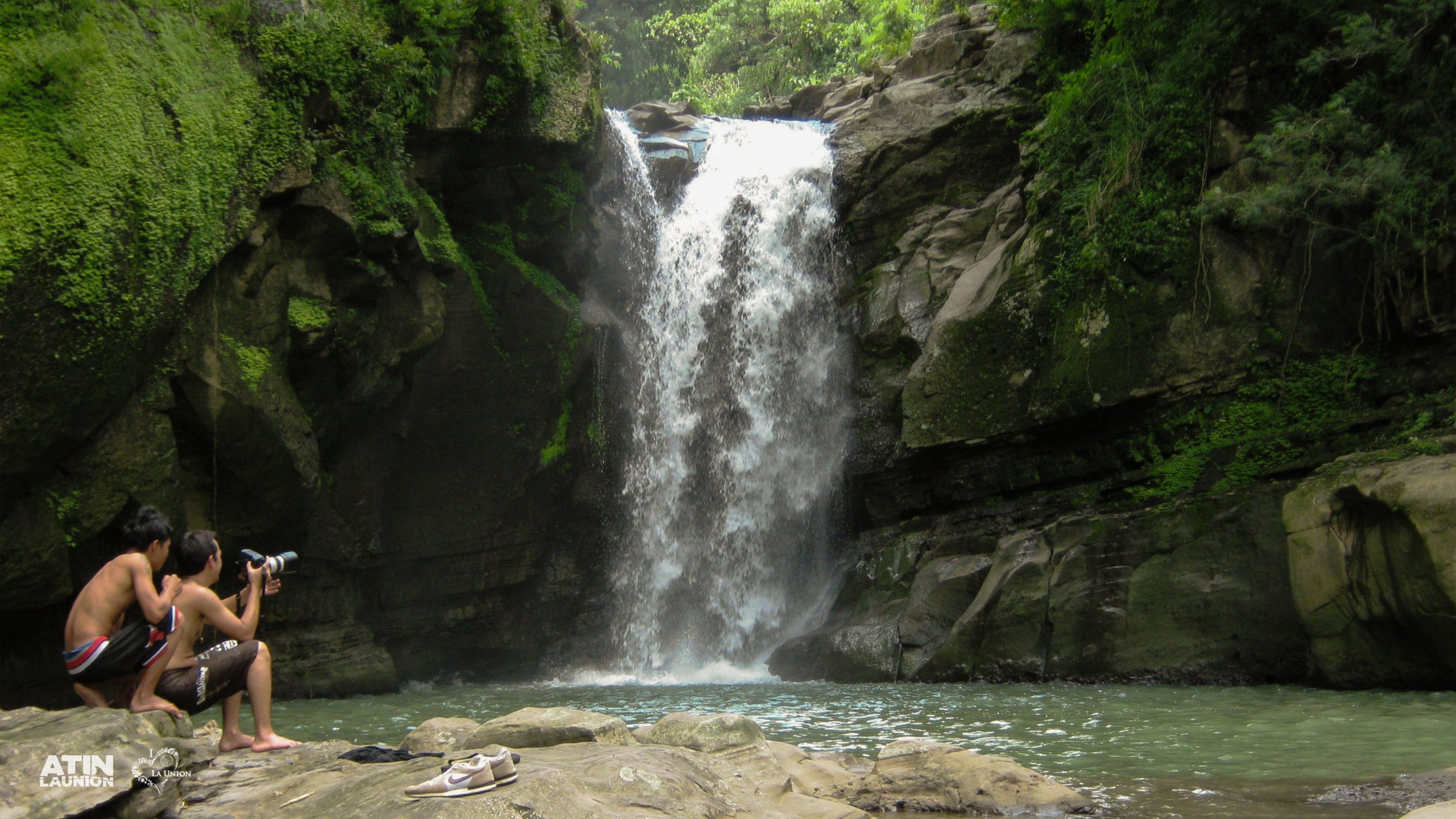 Two kids sitting on the rock near the waterfall area of the La Union Tourist Site, Balay Anito Falls.